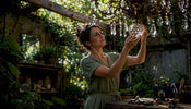 Artisan inspecting crystal finial in restoration workshop