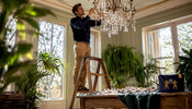 Craftsman installing chandelier crystal strands