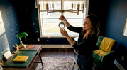 Homeowner placing crystal ornament above light