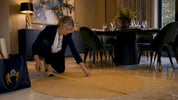 Designer measuring chandelier size on floor