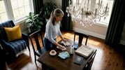 Woman preparing to clean chandelier at home