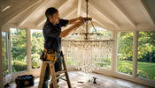 Electrician installing crystal chandelier