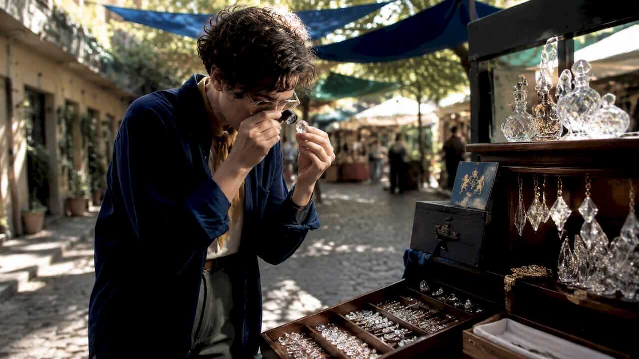 Artisan examining Swarovski crystal facets closely
