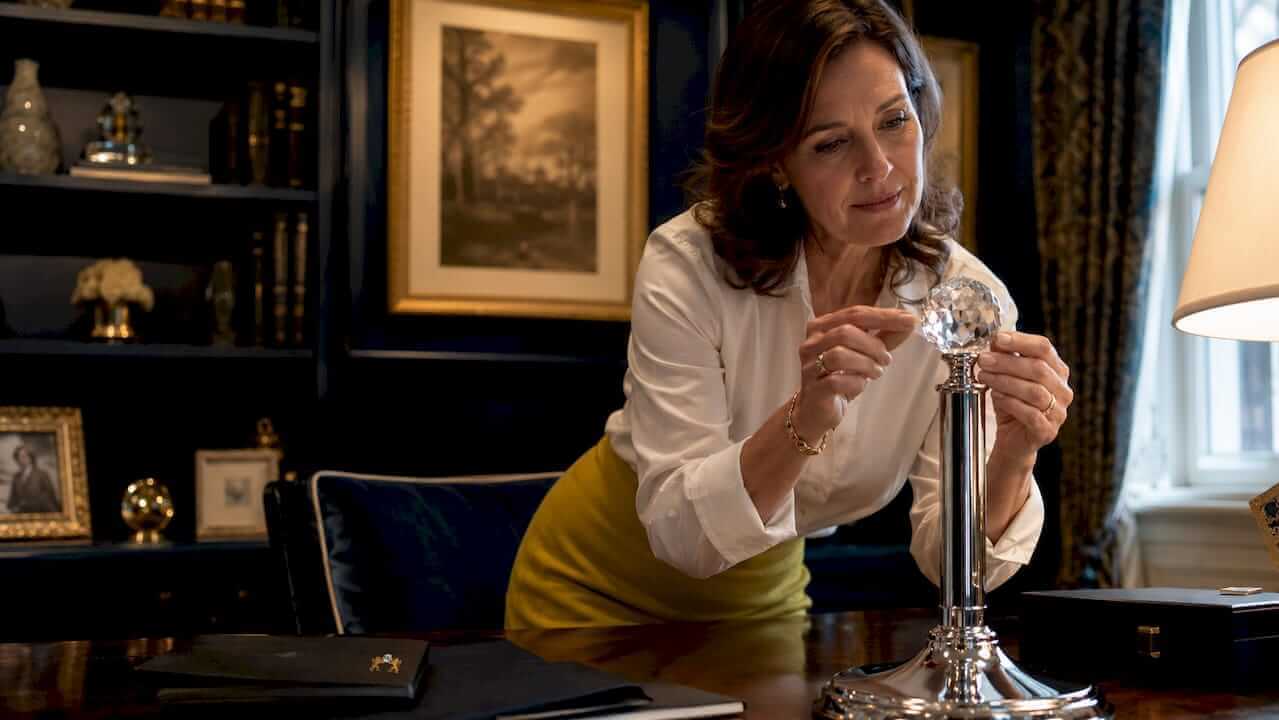 Woman examining crystal finial on lamp