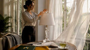 Woman placing crystal finial on lamp