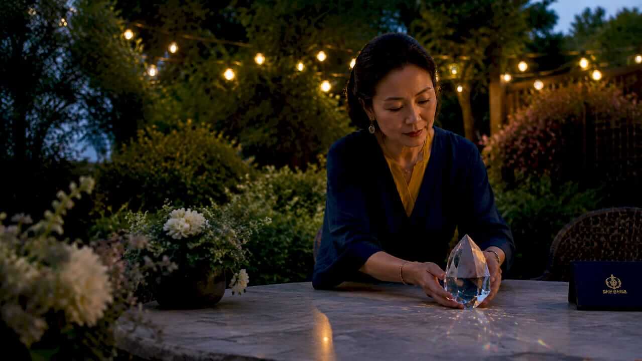Woman placing crystal prism in living room