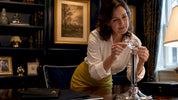 Woman examining crystal finial on lamp