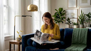 Person reading in living room with layered lighting