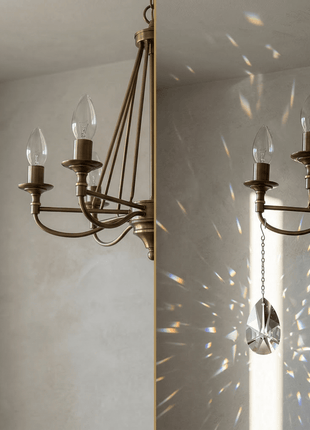 Bronze chandelier with crystal pendant on a neutral wall background