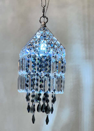 Crystal chandelier-style ornament with black beads on a neutral background by crystalplace.com