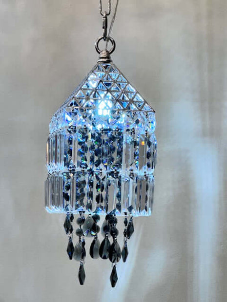 Crystal chandelier-style ornament with black beads on a neutral background by crystalplace.com