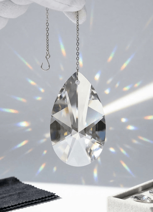 Swarovski crystal hanging with rainbow on a white background