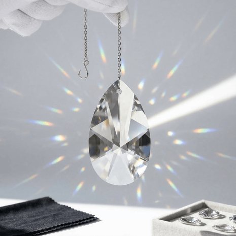 Swarovski crystal hanging with rainbow on a white background