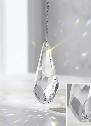 Swarovski Crystal pendant with rainbow effect on a light background