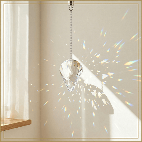 Clear crystal hanging from a chain with rainbow折射效果 on a neutral background