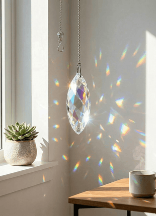 Swarovski Crystal prisms hanging in a room with sunlight casting colorful patterns on the wall.