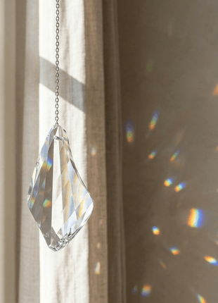 Swarovski Crystal prism hanging by a window with rainbow