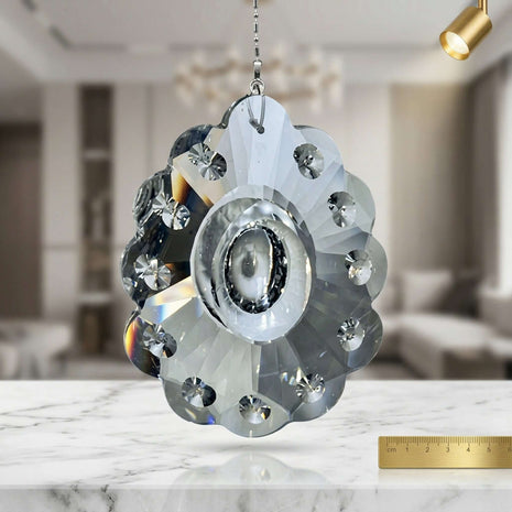 Decorative crystal pendant on a marble surface with a blurred indoor background
