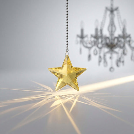 Swarovski star-shaped crystal hanging with a blurred chandelier in the background