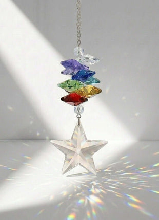 Colorful Swarovski crystal star hanging ornament with rainbow on a gray background