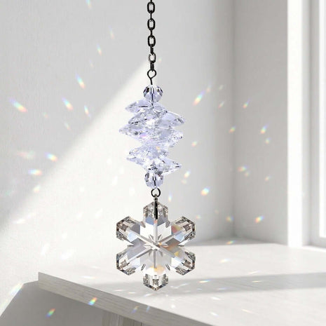 Swarovski Crystal snowflake ornament on a chain against a white background