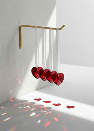Decorative hanging hearts with a gold rod on a white wall