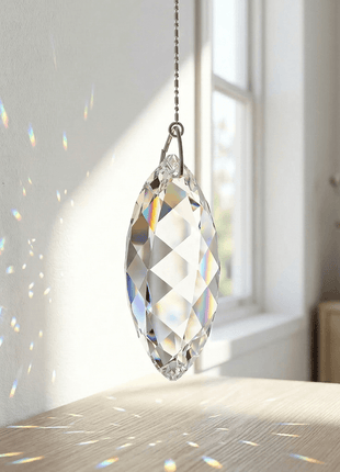 Swarovski Crystal Twist prisms hanging in front of a window with rainbow