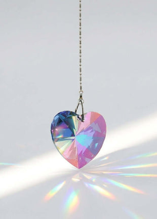 Swarovski Heart-shaped crystal pendant with rainbow colors on a white background