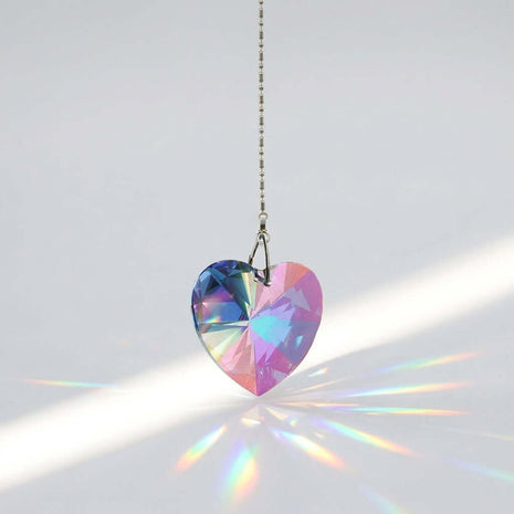 Swarovski Heart-shaped crystal pendant with rainbow colors on a white background