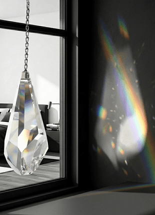 Swarovski Crystal hanging ornament with rainbow effect in front of a window