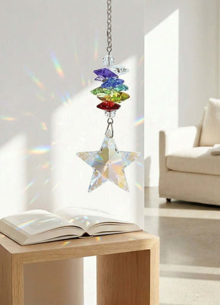 Swarovski Crystal rainbow star hanging above an open book