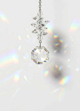 Swarovski Crystal prisms hanging against a white background