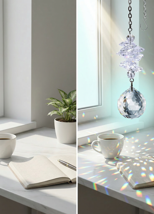Swarovski Crystal hanging ornament casting rainbow colors on a desk with a cup, notebook, and plant.