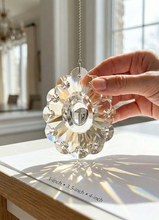 Hand holding a crystal sunflower ornament with a blurred indoor background