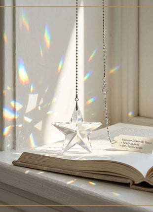 Swarovski Star-shaped crystal hanging on a window sill with rainbow