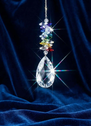 Swarovski Crystal rainbow maker hanging against a dark blue curtain
