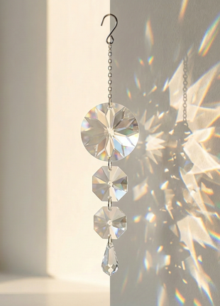 Crystal sun catcher hanging on a window with rainbow