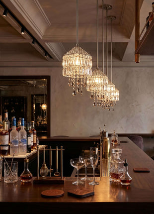 Bar setup with bottles, glasses, and decorative lights in a stylish interior by crystalplace.com