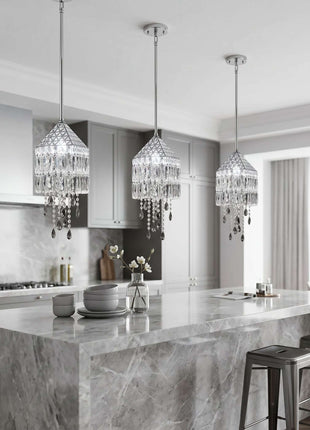 Modern kitchen with marble island and crystal pendant lights by crystalplace.com