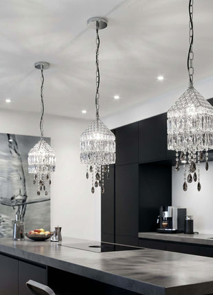 Modern kitchen with three crystal pendant lights hanging above a island by crystalplace.com