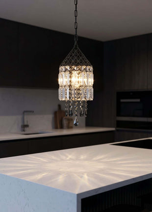 Chandelier hanging above a kitchen island with a modern kitchen by crystalplace.com 